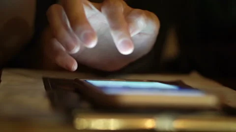 Hand scrolling and playing smart phone at night close up shot Video stock 66592666