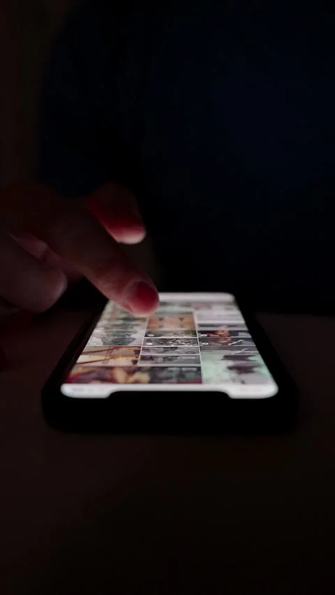 Hand scrolling on smartphone screen in dark environment Stock Footage 264981941