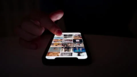 Hand scrolling on smartphone screen in dark environment Stock Footage 264981942