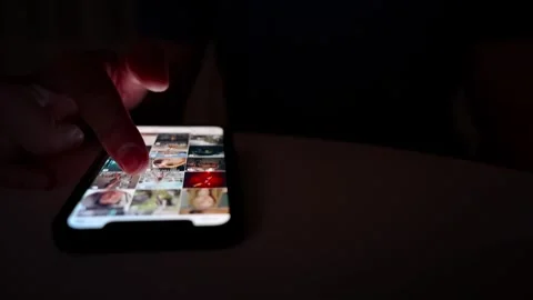 Hand scrolling on smartphone screen in dark environment Stock Footage 264981943
