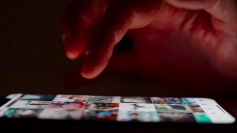 Hand scrolling on smartphone screen in dark environment Stock Footage 264982005