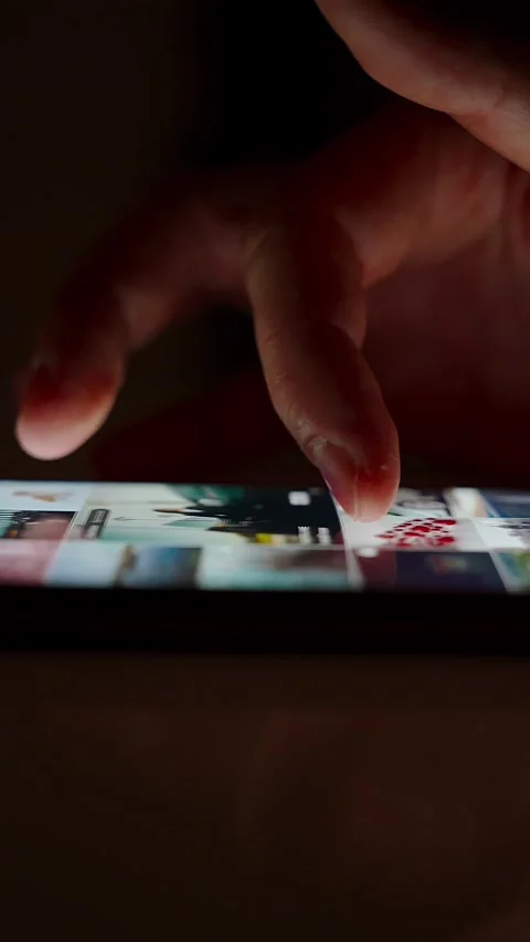 Hand scrolling on smartphone screen in dark environment Stock Footage 264982012