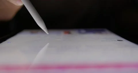 Hand scrolling through photos on digital tablet Stock Footage 228674635