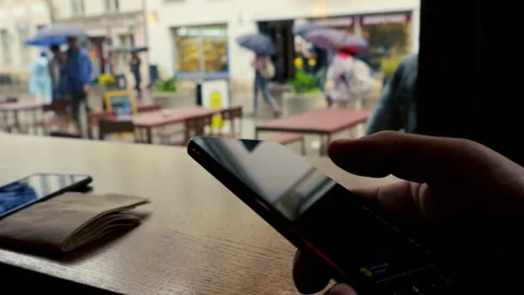 Hand Scrolling Through Social Media Feed on Smartphone in Cafe 動画素材 336937534