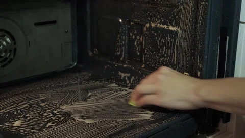 Hand scrubbing oven interior with sponge Stock Footage 340016095