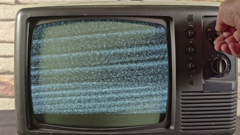 A Hand Is Seaching For A Channel On An Old TV Camera Zooming Out 1 Stock Footage 157404059