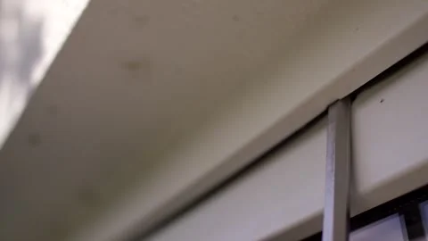 Hand seals upper window frame from outside, close up of weatherstripping Stock Footage 341525198