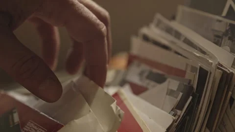 Hand Searches Through Box of Old Family Photographs Filled with Memories Stock Footage 337763960