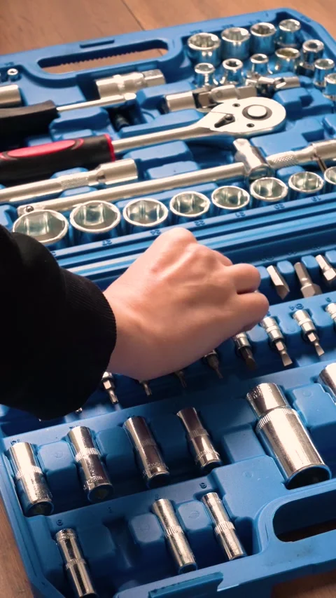 Hand searching through a professional socket wrench and screwdriver tool set Stock Footage 346234645