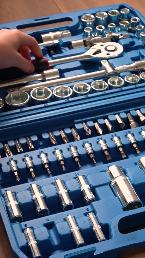 Hand searching through a professional socket wrench and screwdriver tool set Stock Footage 346234677