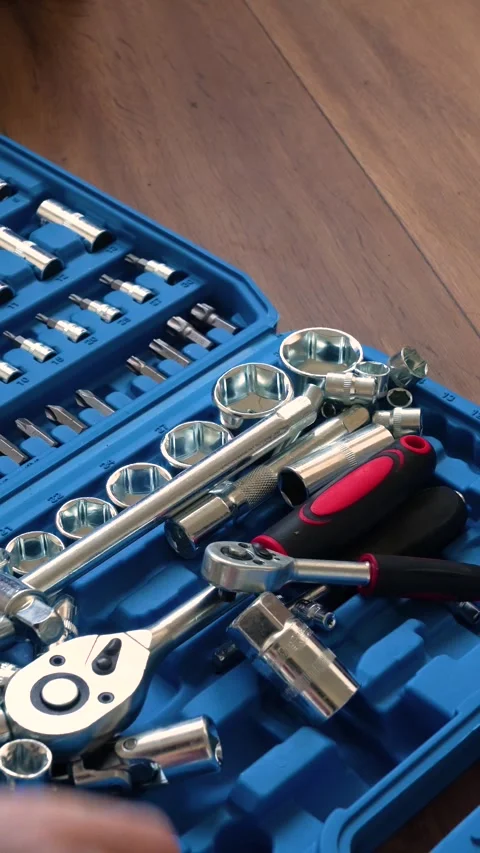 Hand searching through a professional socket wrench and screwdriver tool set Stock Footage 346234834