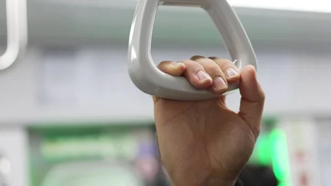 Hand securely holds grab handle in subway. Safety feature ensures stability Stock Footage 322047794