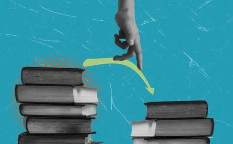 A hand is seen jumping across a gap between two piles of books. The backgroun Stock Photos