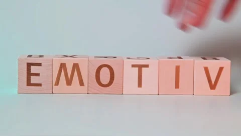 A hand is seen manipulating wooden blocks to form different words focusing on Stockbeeldmateriaal 338187655
