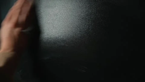 A hand is seen writing mathematical equations on a chalkboard in a classroom. Stock Footage 338186475