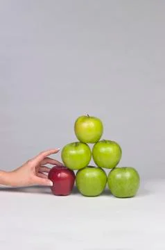 Hand selecting an apple from a stack Stock-Fotos