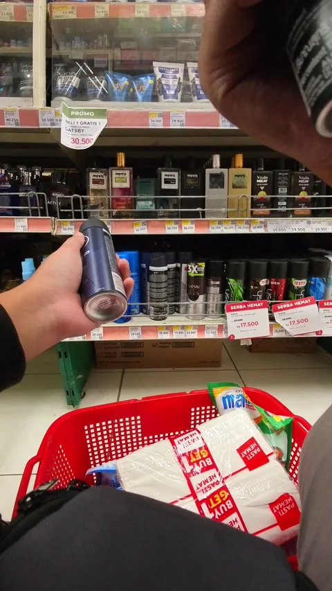 A hand selecting body spray from a men&amp;#039;s perfume rack Stock-Footage 328615854
