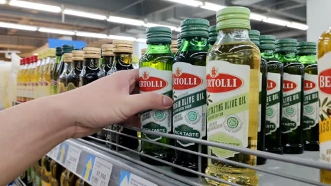 Hand Selecting a Bottle of Olive Oil in a Grocery Store Aisle Stock Footage 305367688