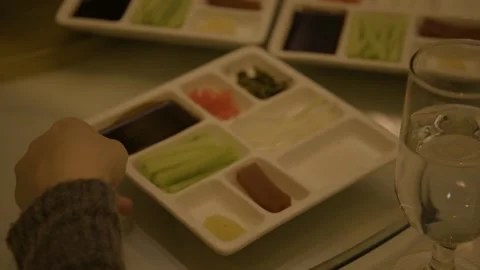 Hand Selecting Condiments and Vegetables from Divided Plate in Beijing Stock Footage 345783291