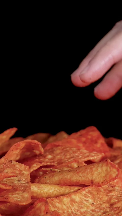 Hand Selecting Crispy Nacho Chips From Pile Against Black Background Stock Footage 320163598