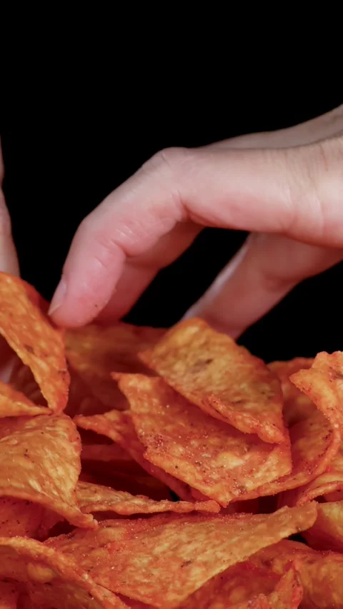 Hand Selecting Crispy Tortilla Nacho Chips Against Black Background Stock Footage 321857901