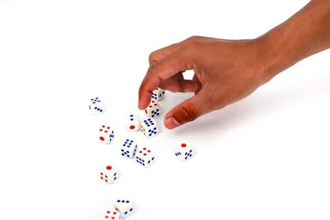 Hand Selecting Dice With Red And Blue Dots On A White Background Stock Photos