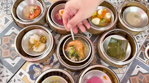 Hand Selecting Dim Sum from Assorted Bas... | Stock Video | Pond5