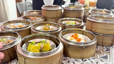 Hand Selecting Dim Sum Baskets at Restaurant Table Video stock 317210564