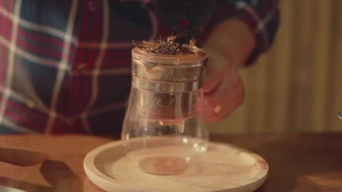 Hand Selecting Dried Tea Leaves for Brewing with Glass Tea Press Video stock 306436221