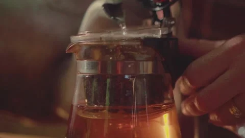 Hand Selecting Dried Tea Leaves for Brewing with Glass Tea Press Stock Footage 306436310