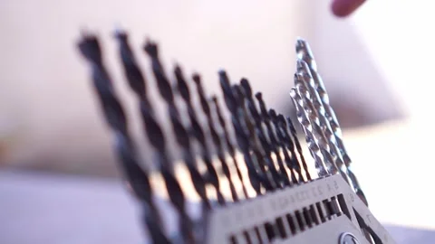 Hand selecting drill bit from tool case, close up shot, metal drill bits set, Stock Footage 345871004