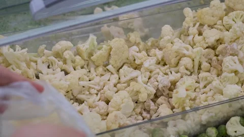 Hand Selecting Fresh Cauliflower Florets at a Market Stock Footage 308363936