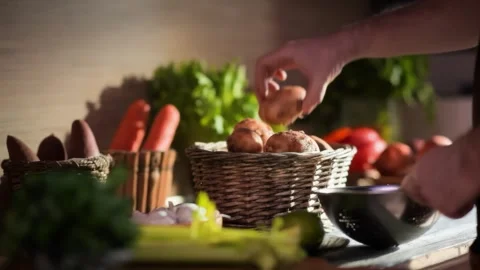 Hand selecting fresh new potatoes from a farmers market basket Stock Footage 311891603