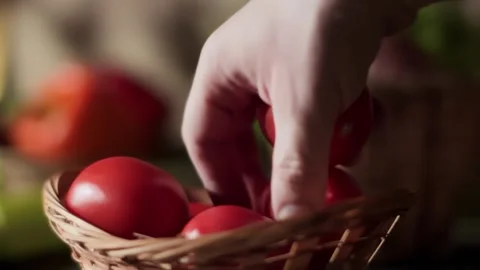 Hand selecting fresh ripe tomatoes from a wicker basket Stock Footage 314111483