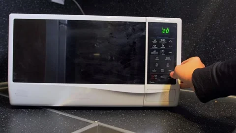 Hand selecting microwave program close-up shot on control panel with finger 動画素材 333649292