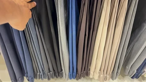 Hand Selecting paint Fabric From Textile Display At retail Showroom Stock Footage 340957364