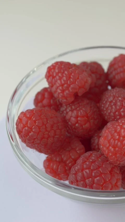 Hand selecting raspberry illustrates consumer choice, food quality selection Stock Footage 333114835