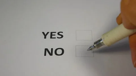 A hand selects the Yes or No column in the ballot Stock Footage 289511132