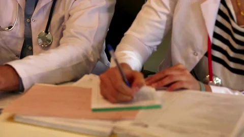 Hand of senior doctor taking notes in office Low angle view of male medical Stock-Footage 336587688