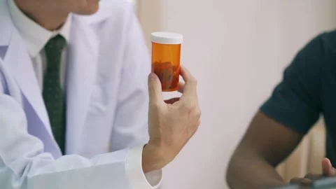 Hand of senior doctor taking notes in office Low angle view of male medical Stock Footage 336588348