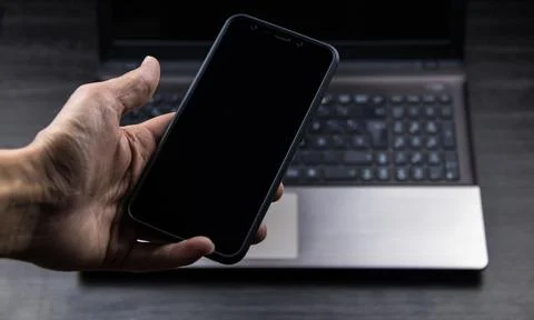 Hand of senior person using a modern mobile in a workspace Stock Photos