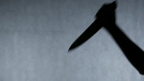 Hand of serial killer stabbing victim multiple times with a knife, crime scene Stock Footage 87670671