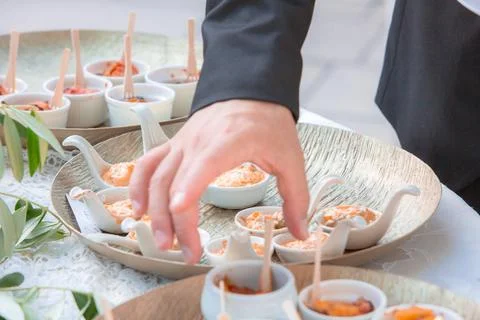 Hand serving appetizers at a catering event buffet 库存照片