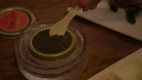 Hand Serving Caviar from Tin on Ice at Restaurant Table in Beijing, China Stock Footage 345762876