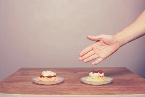 Hand serving cream tea Stock Photos