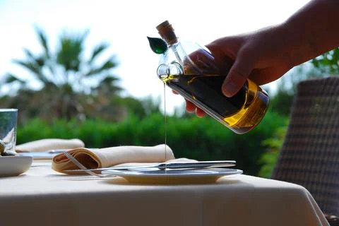 Hand serving pepper and extra virgin olive oil Stock Photos