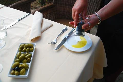 Hand serving pepper and extra virgin olive oil Stock Photos