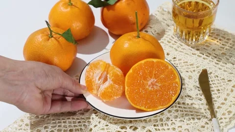 Hand Serving Plate of Fresh Sliced Oranges 4K Stock Footage 340451961