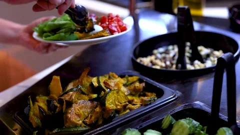 Hand Serving Roasted Pumpkin at Self-Service Salad Bar Stock Footage 323339628