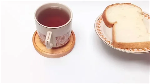 Hand serving white bread on plate near hot black coffee cup view Stock Footage 344782735